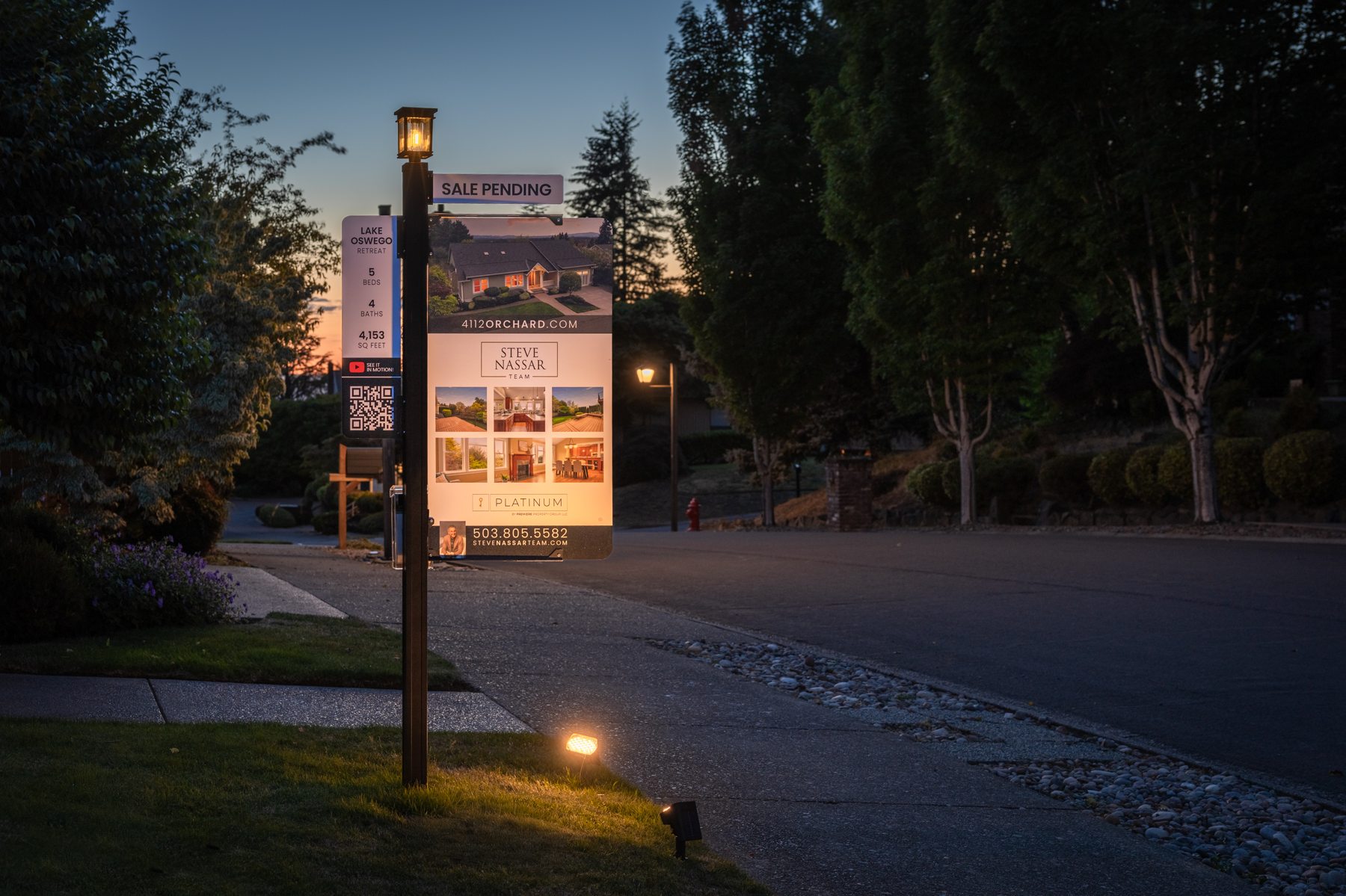 Illuminated Platinum Spire property sign at dusk